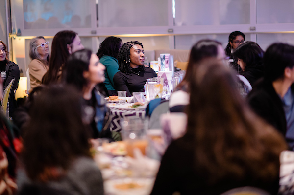 Students watch keynote speaker with riveted expressions 